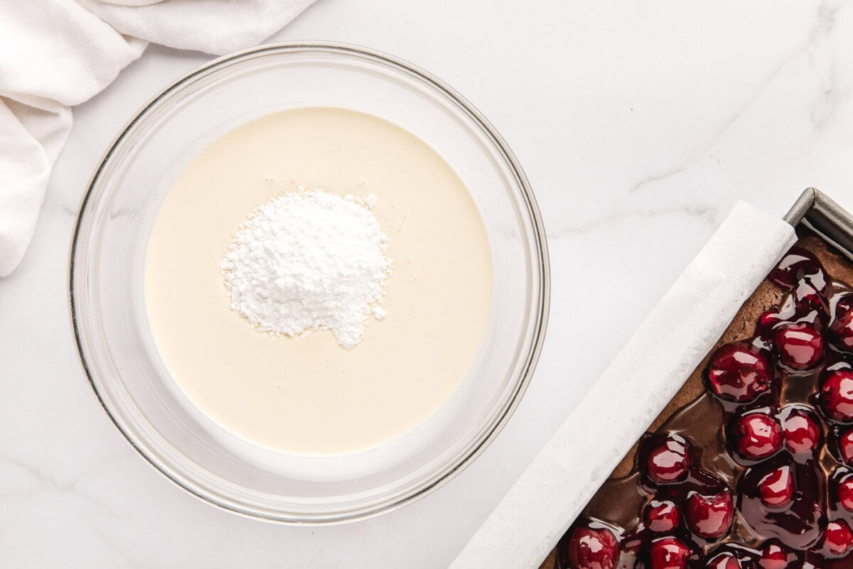 powdered sugar and heavy whipping cream in a bowl