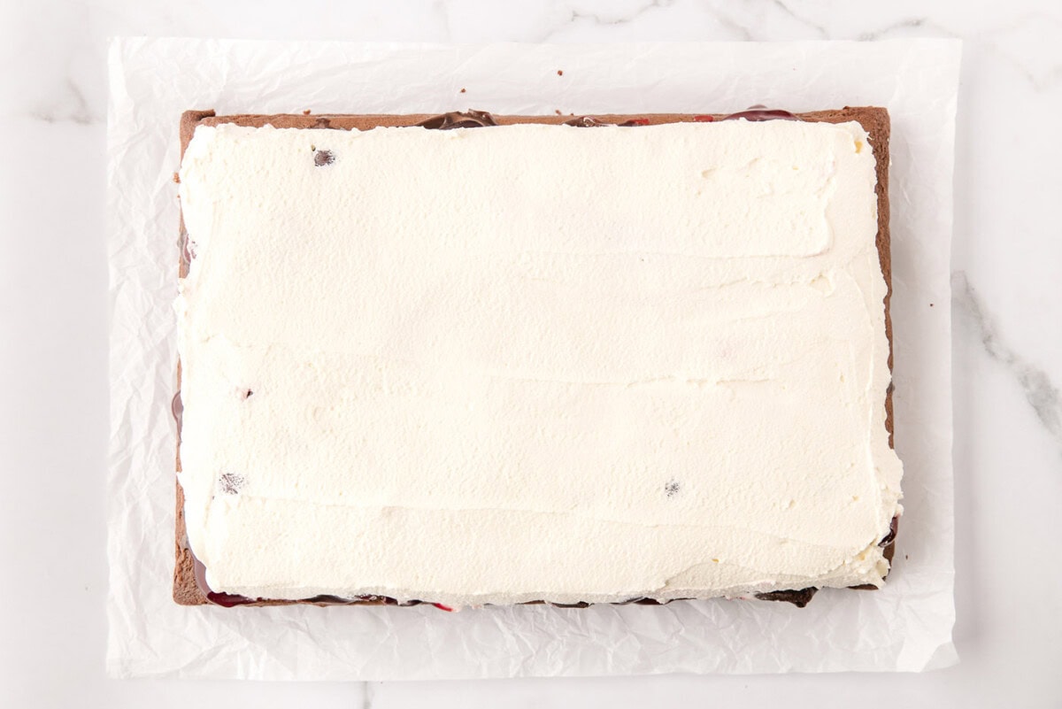 whipped cream topping on black forest poke cake