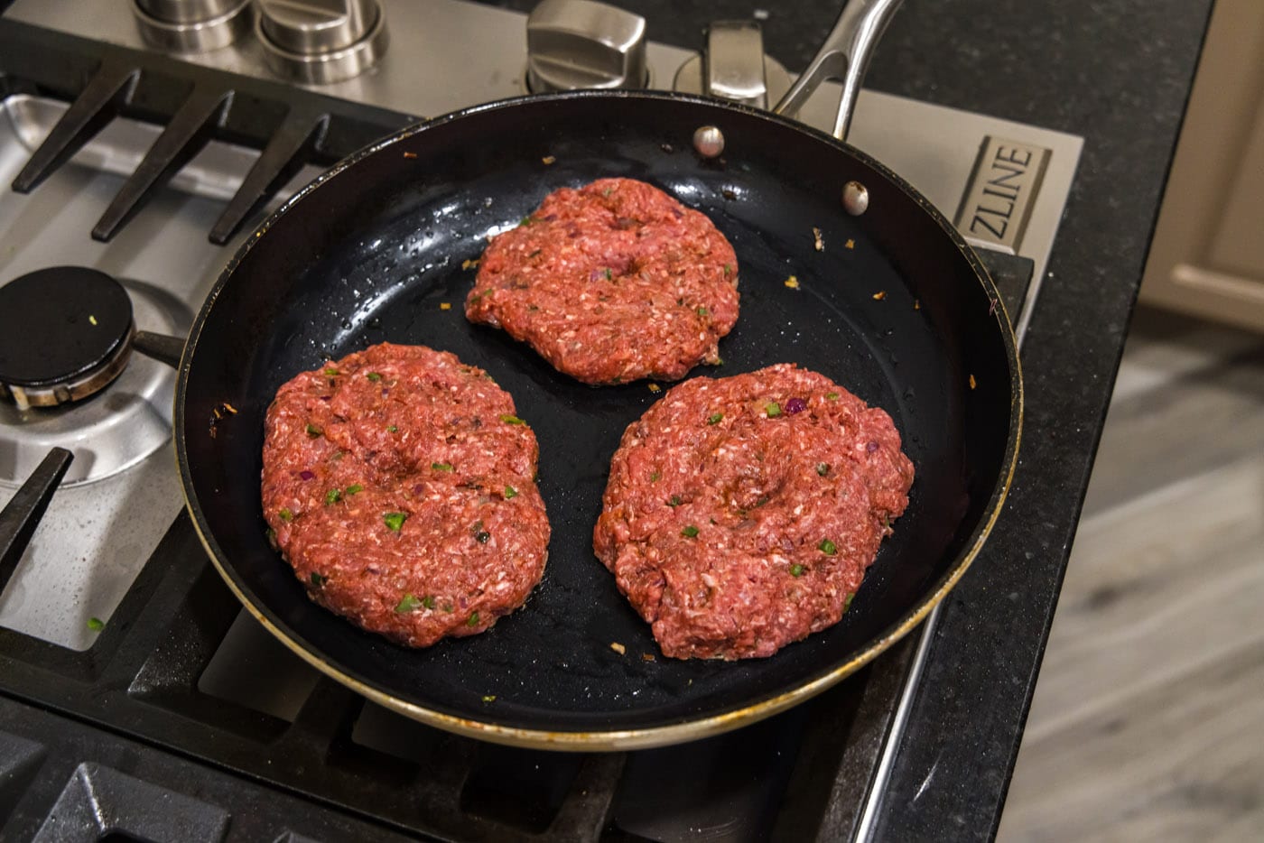 cooking bison burgers in a skillet