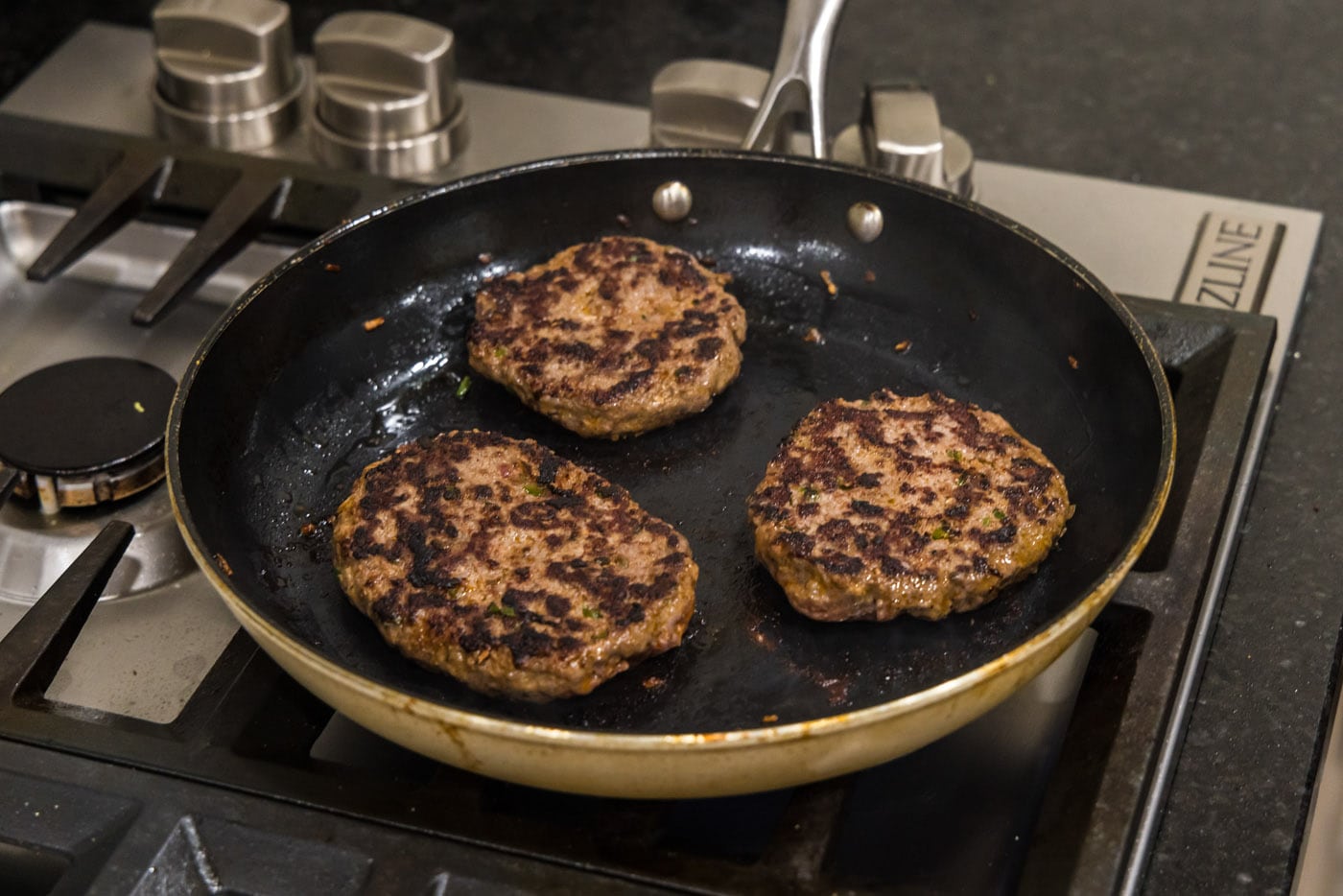 cooked buffalo burgers in a skillet