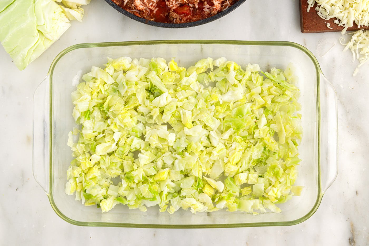 chopped cabbage on bottom of a baking dish
