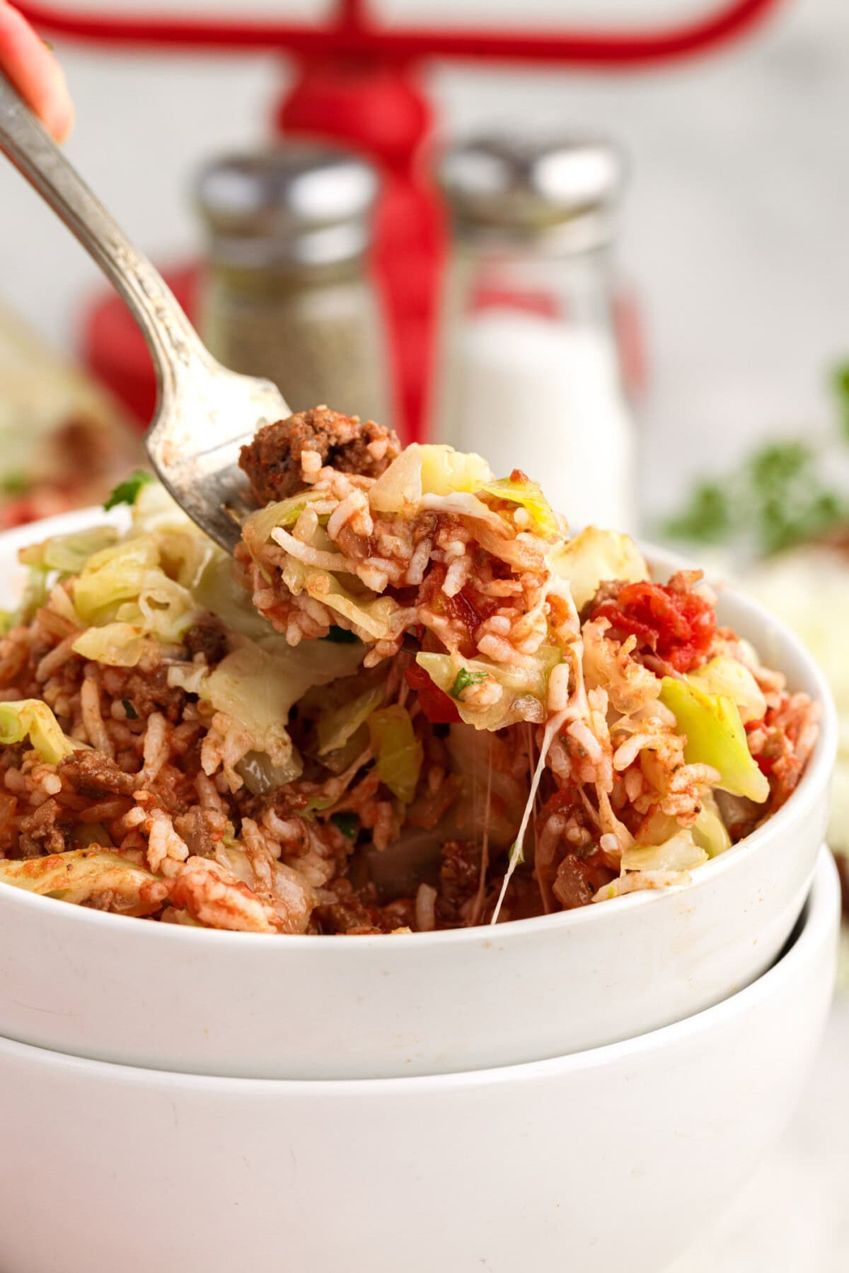 Forkull of Cabbage Roll Casserole being lifted out of a bowl of Cabbage Roll Casserole