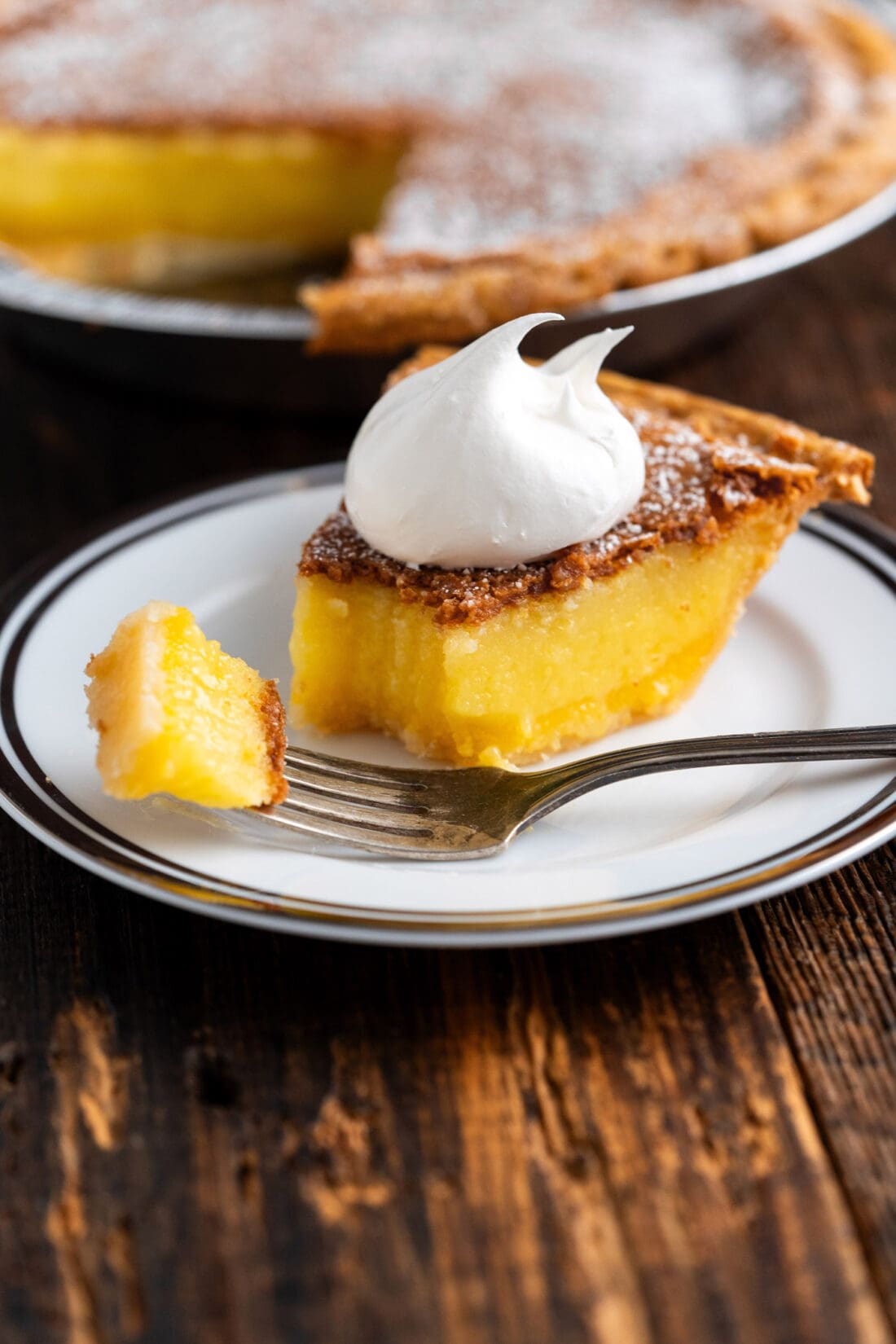 Slice of Chess Pie on a plate with a bite on a fork
