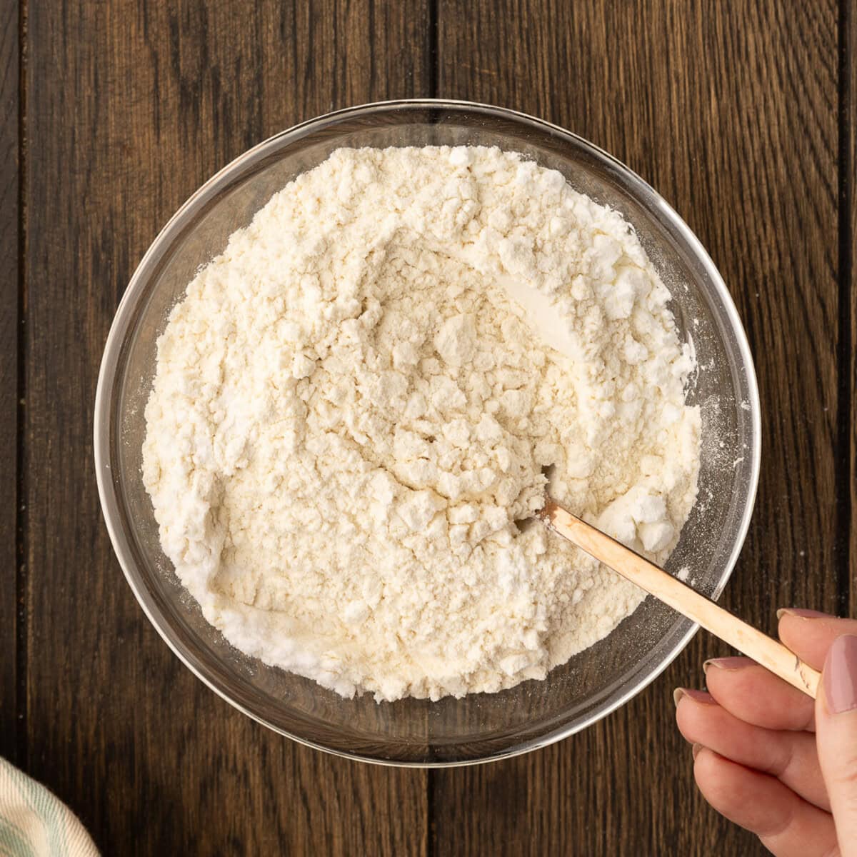 mixing dry ingredients for cookie dough in a bowl