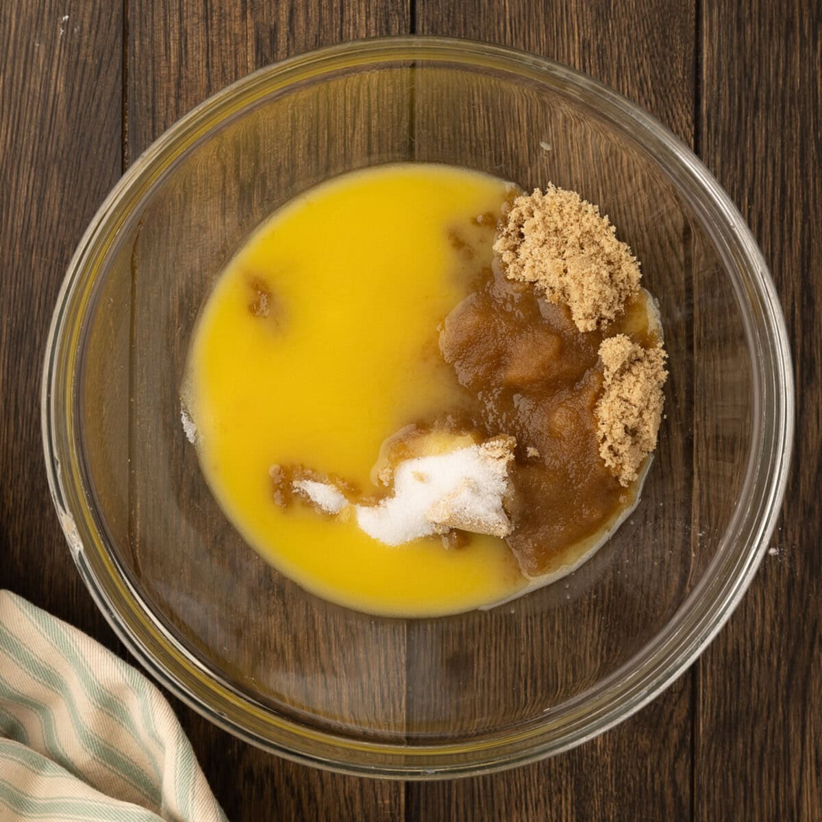 mixing wet ingredient for chocolate chip cookies in a bowl