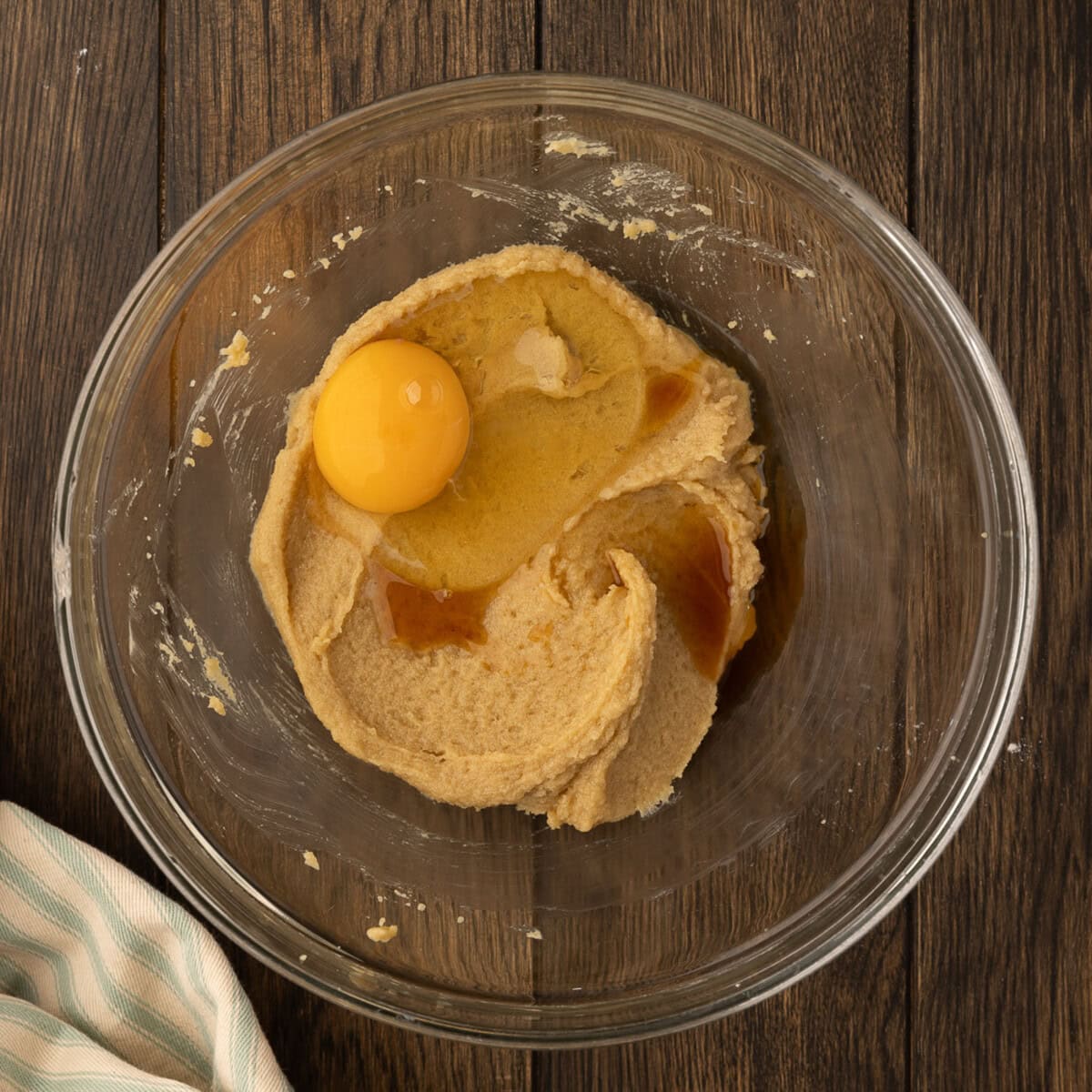 adding egg and vanilla to cookie dough
