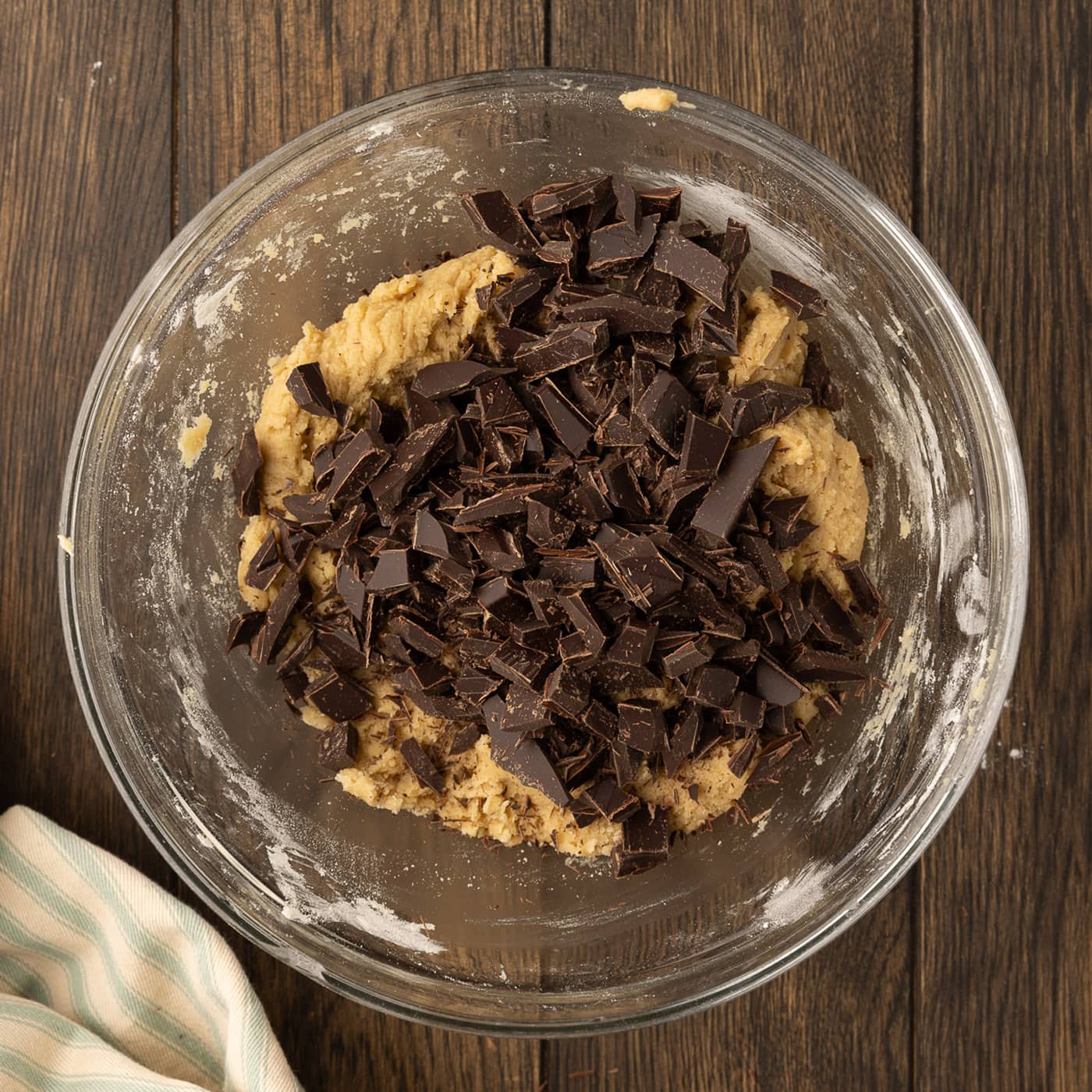 chopped chocolate added to bowl of cookie dough