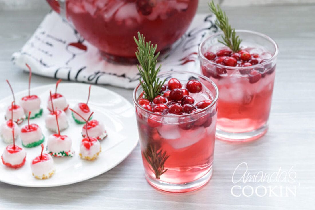 holiday punch glasses with spiked cherries on a plate