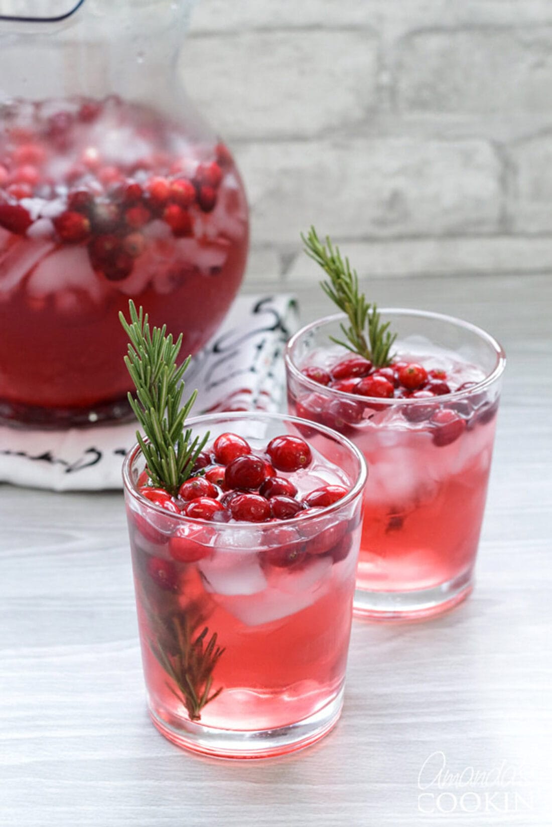 cranberry holiday punch with rosemary sprigs as garnish