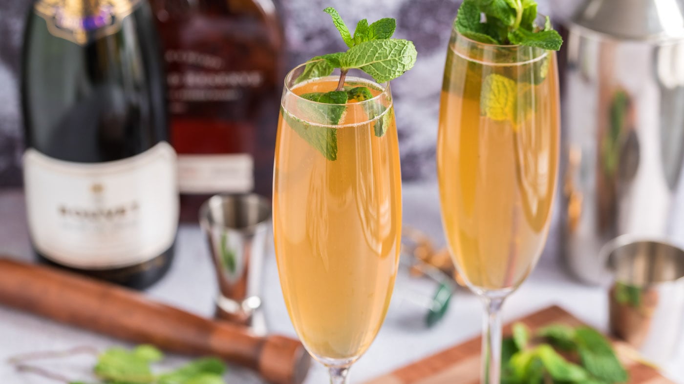 Muddled mint, a dash of sugar, a kick of bourbon, and a touch of fizz from the champagne create an e