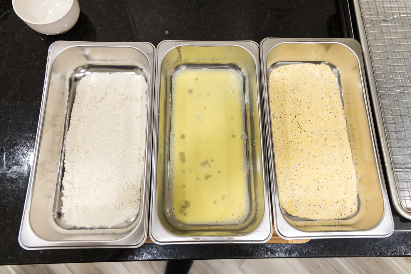 dredging station with flour, egg mixture, and cornmeal mixture