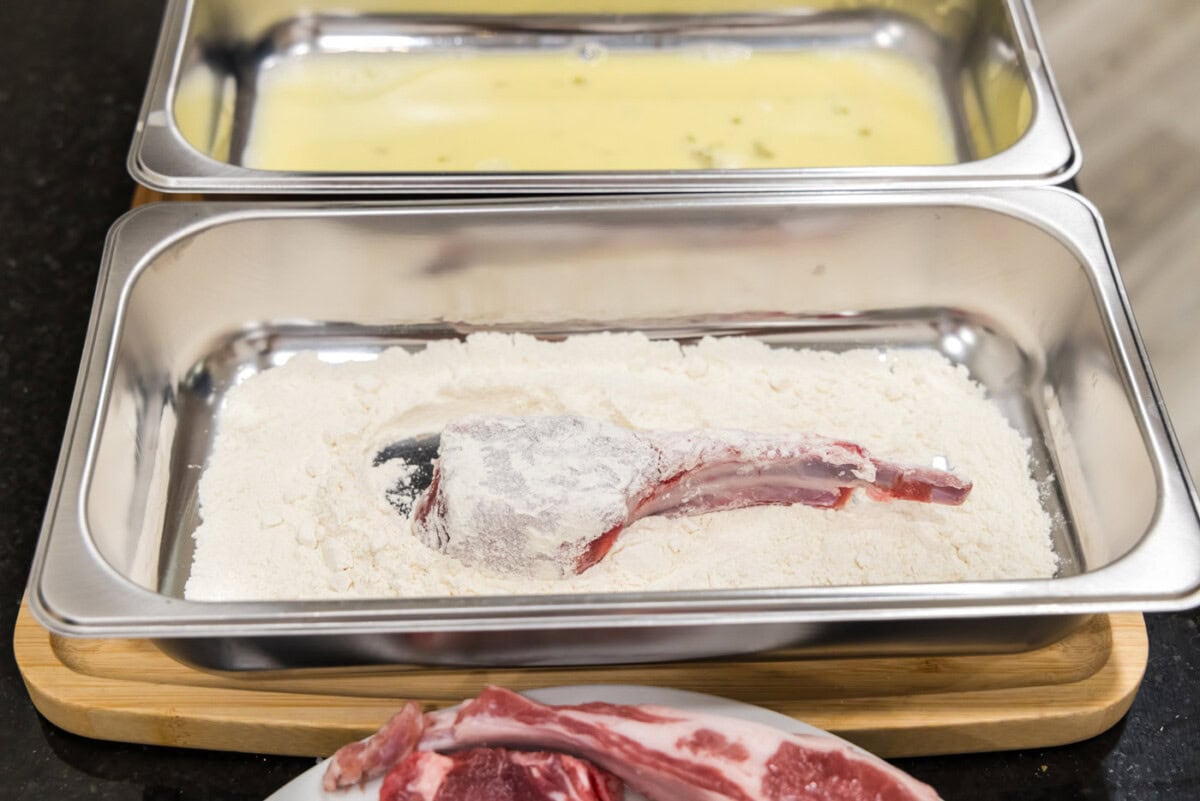 dredging lamb chop in flour