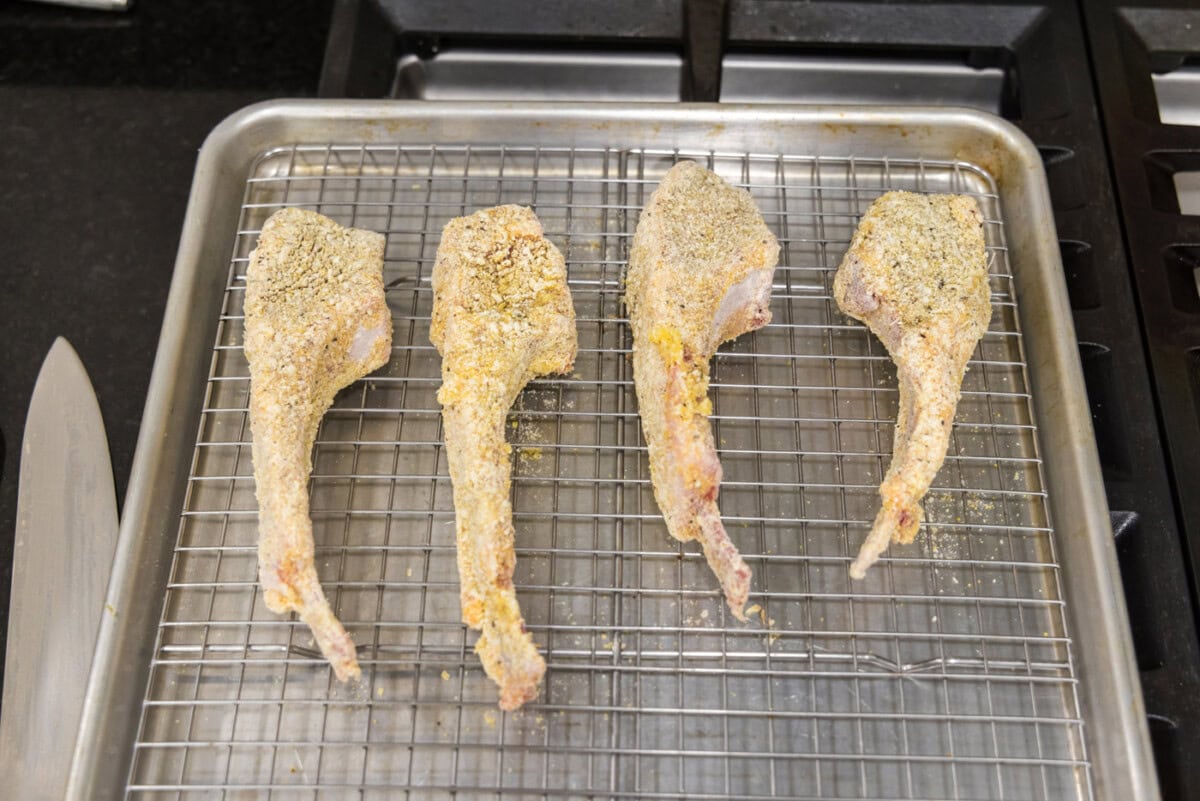 dredged lamb chops on a wire rack