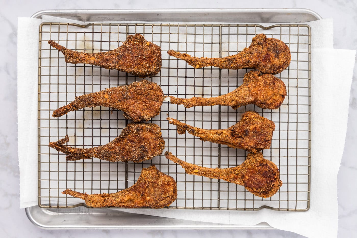 golden crusted fried lamb chops on a wire rack