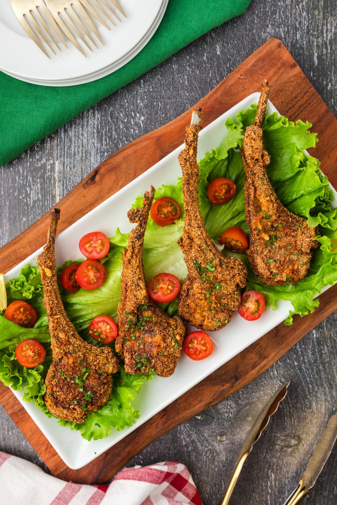 Fried Lamb Chops plated on a bed of lettuce