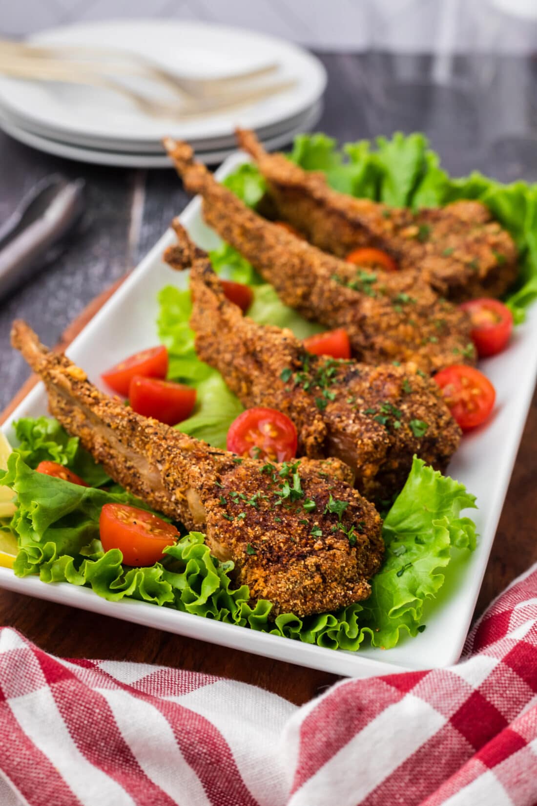 Side photo of Fried Lamb Chops resting on a bed of lettuce