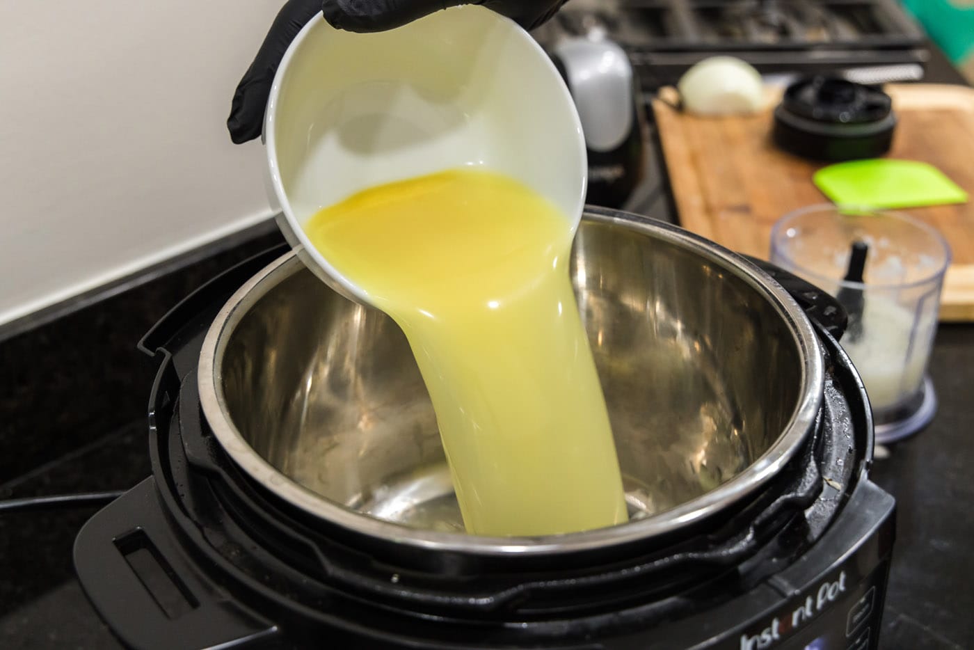 pouring chicken stock into instant pot