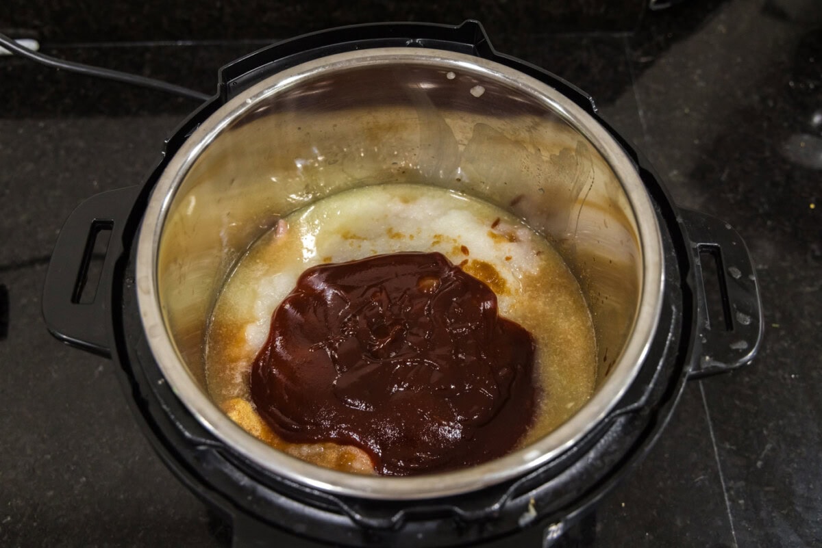 barbecue sauce added to chicken and stock in the instant pot