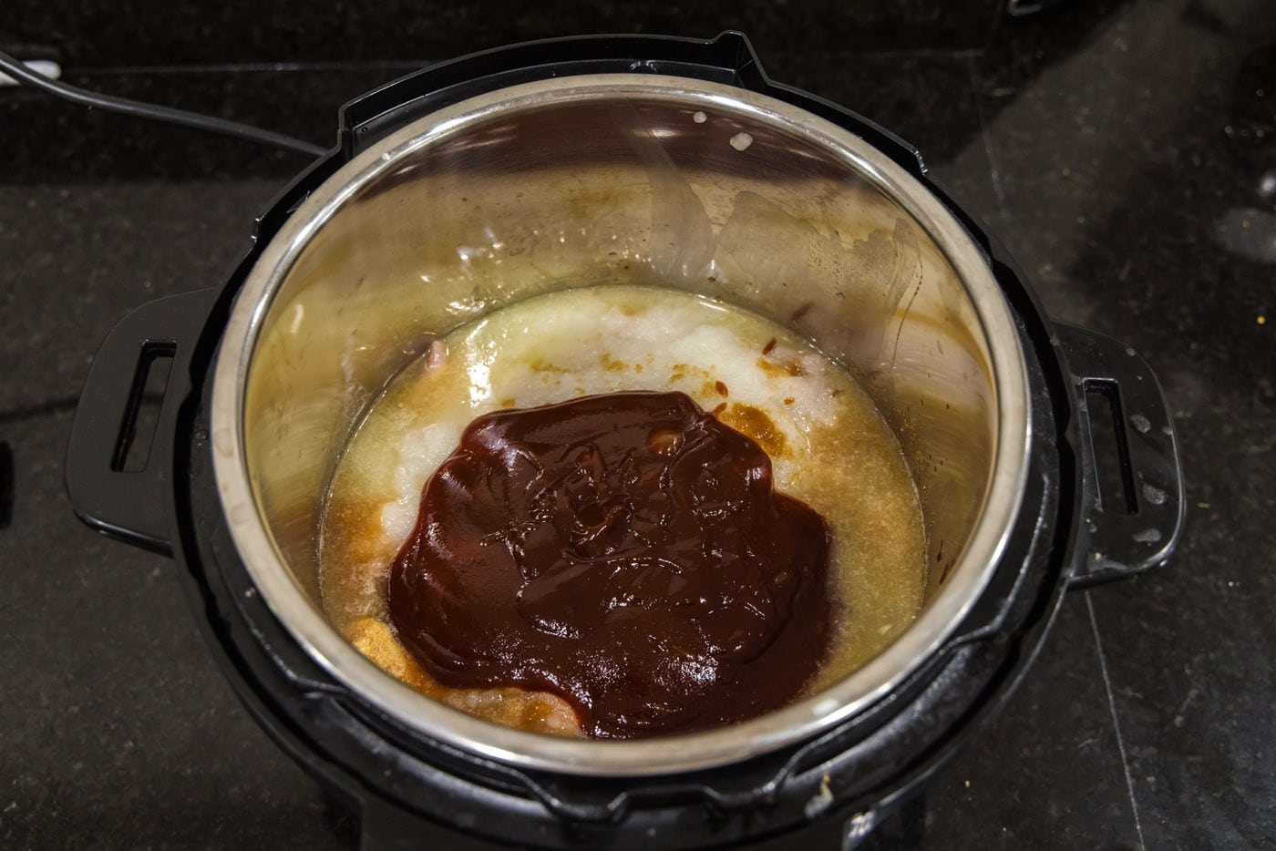 barbecue sauce added to chicken and stock in the instant pot