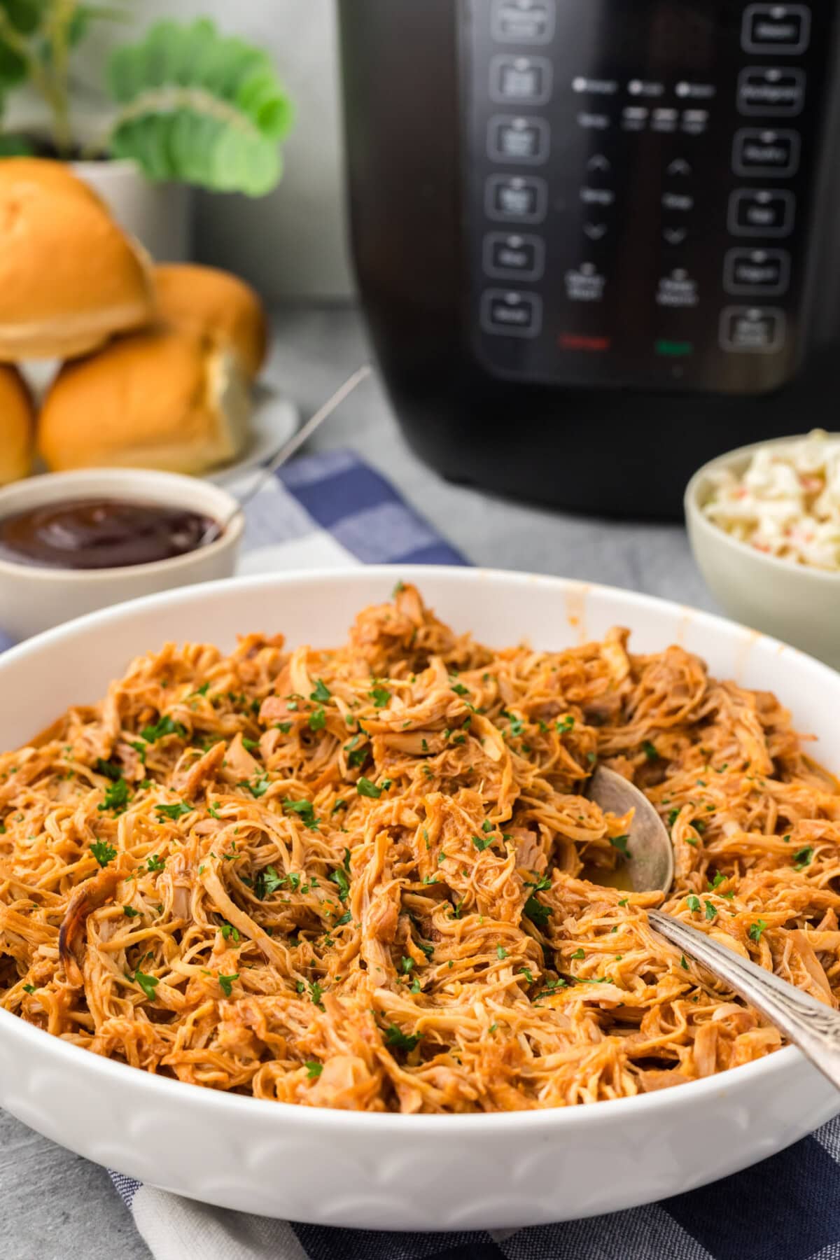 Instant Pot BBQ Chicken in a bowl with a spoon in it