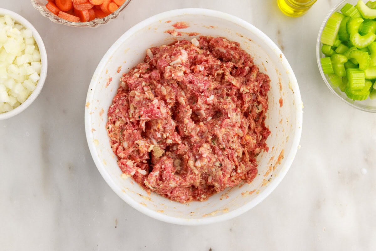 italian sausage and ground beef meatball ingredients in a bowl
