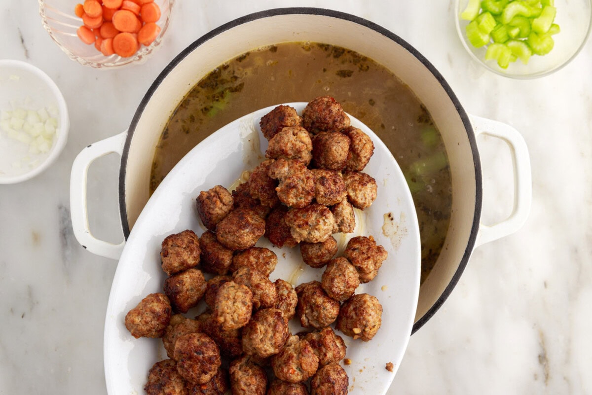 adding meatballs to Italian wedding soup