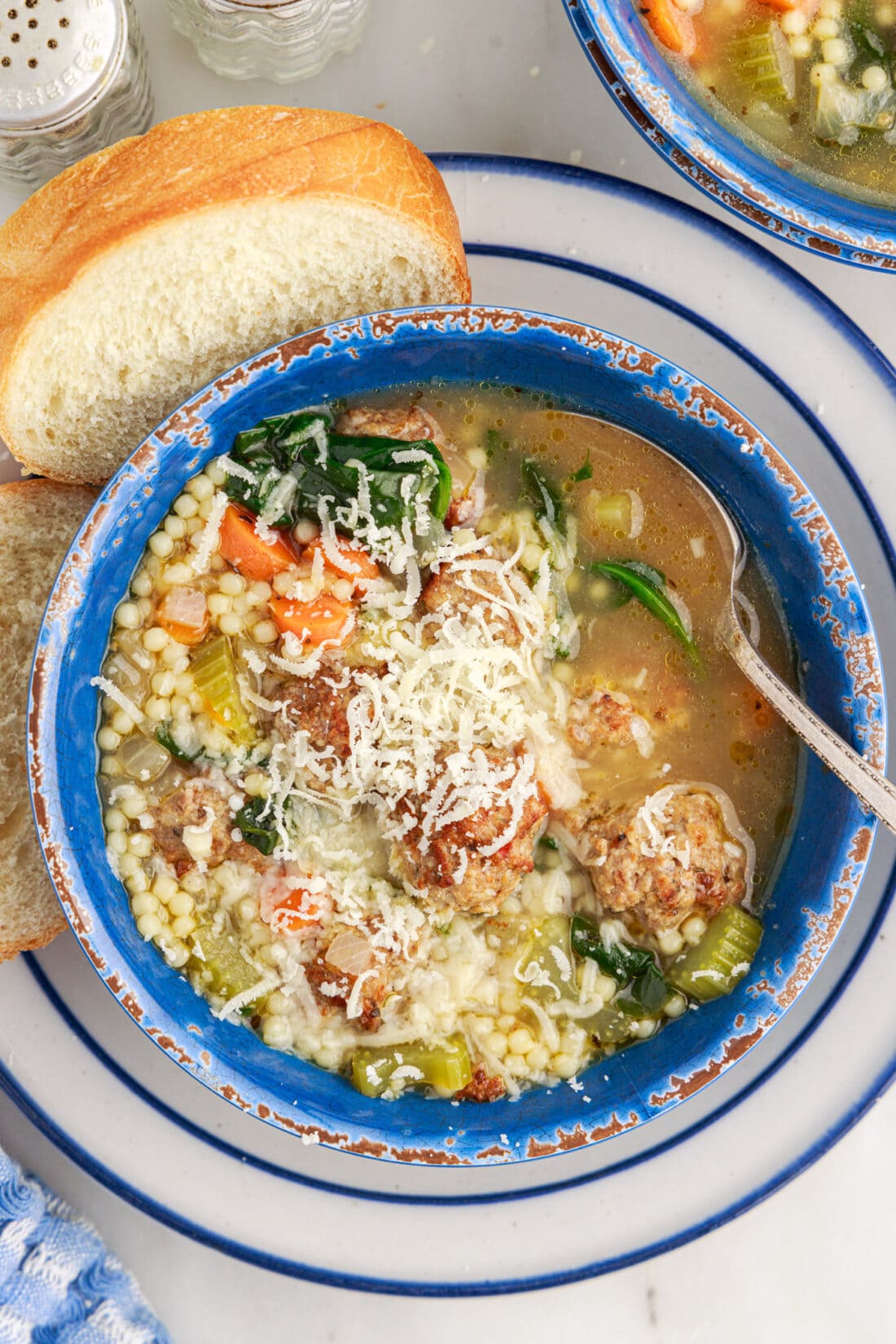 Bowl of Italian Wedding Soup topped with cheese