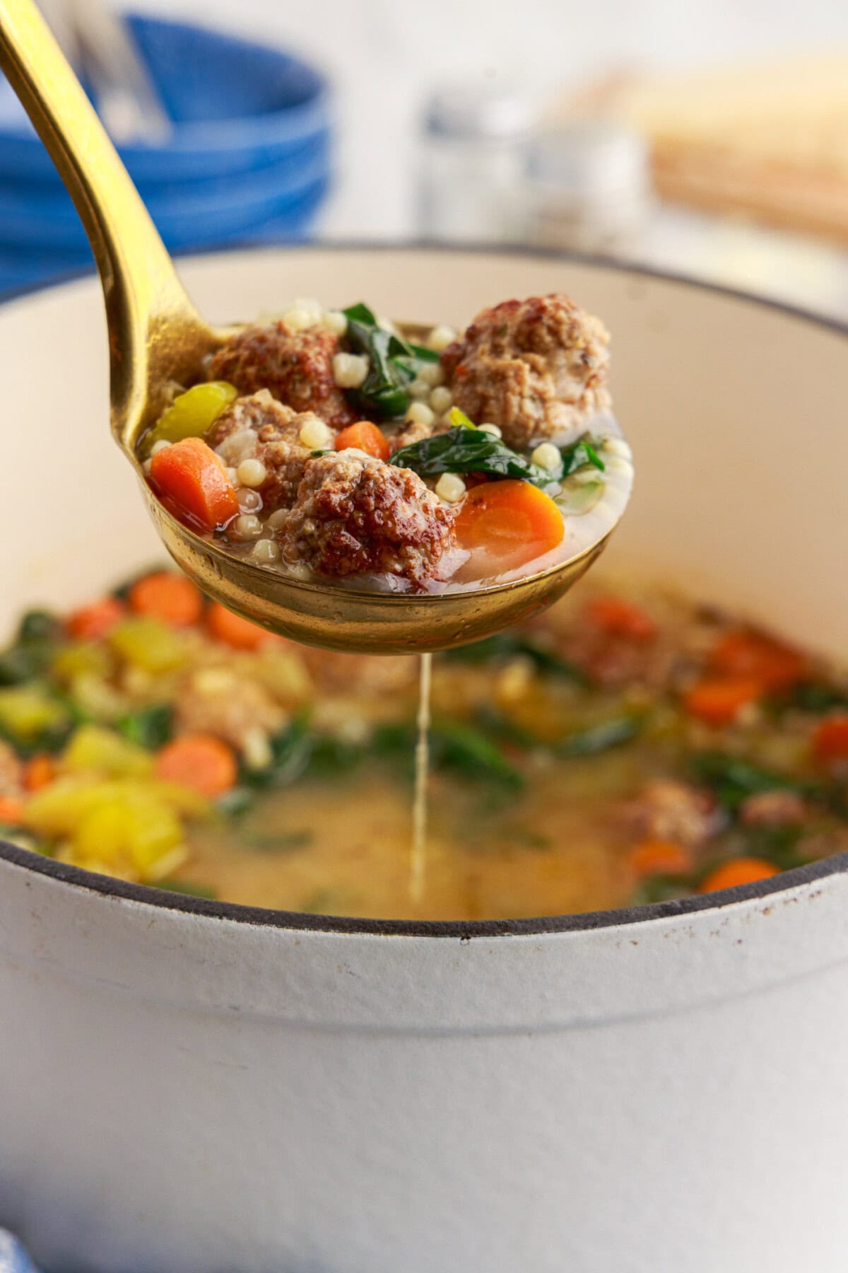 Ladle of Italian Wedding Soup held above a pot of Italian Wedding Soup