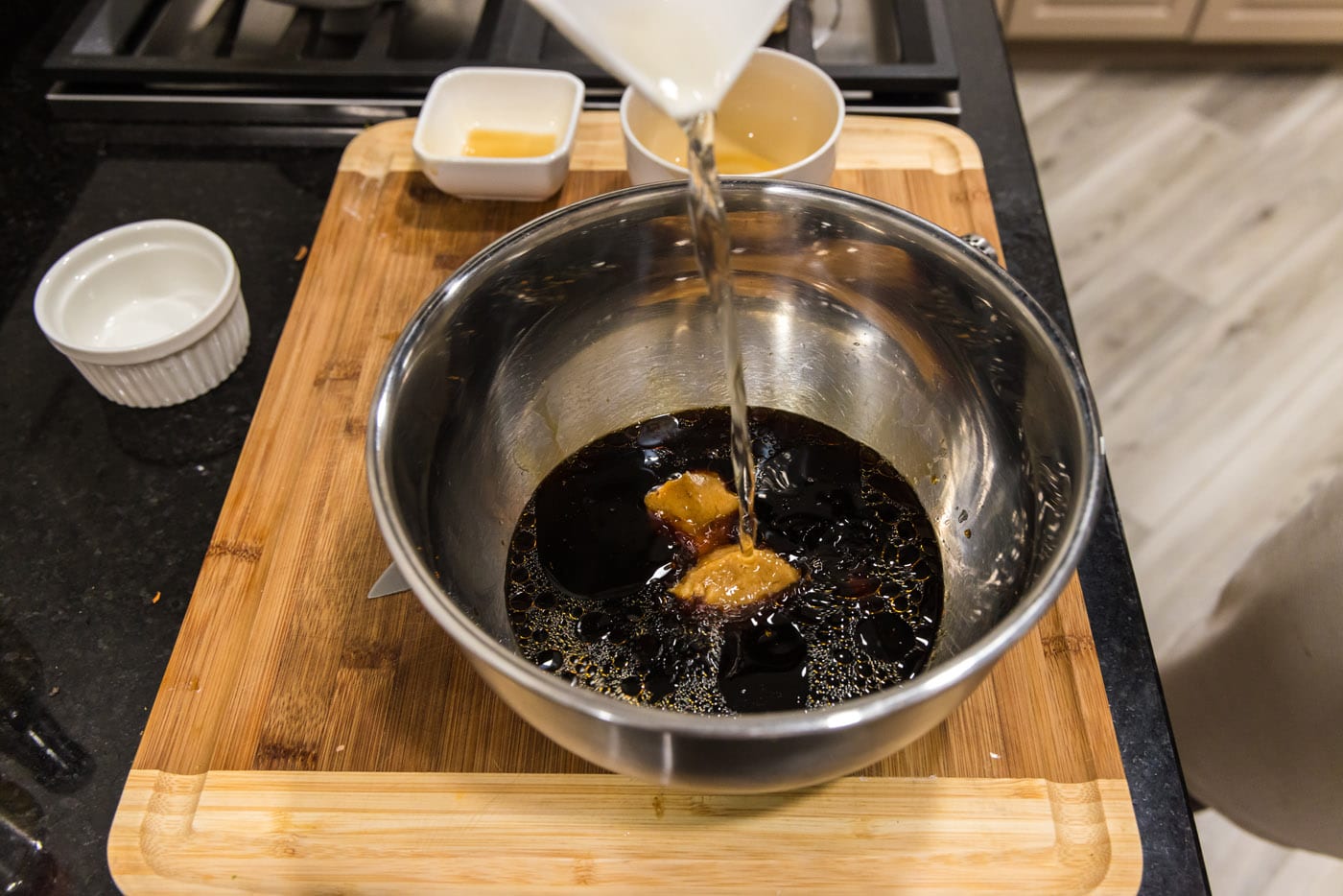 pouring marinade ingredients into a bowl