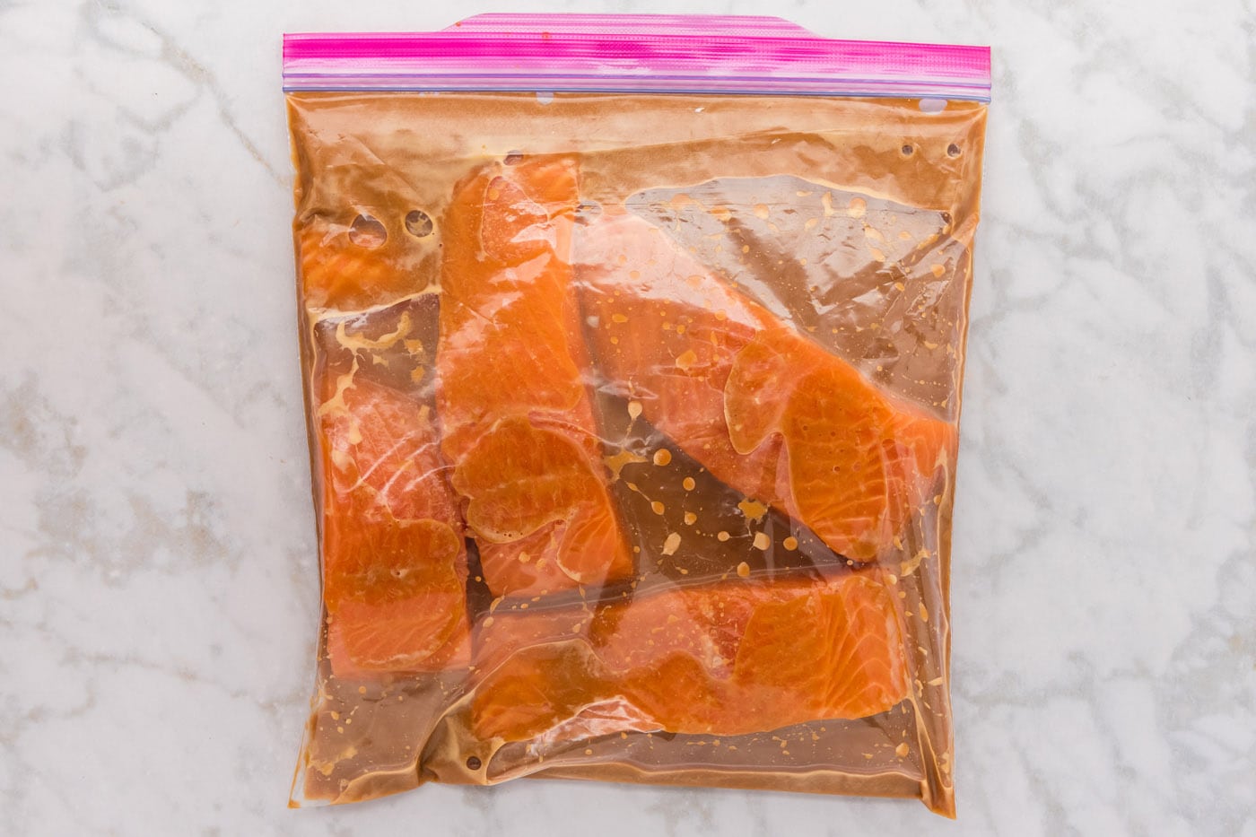miso salmon marinating in a gallon zipper bag