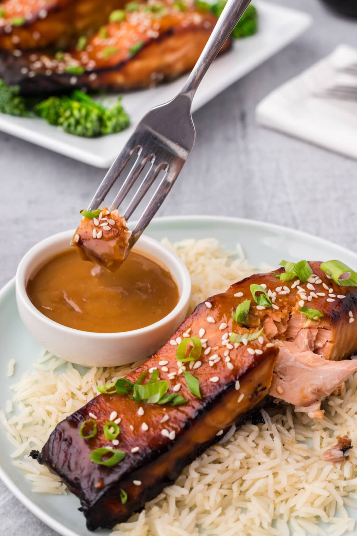 Piece of Miso Salmon being dipped into miso sauce