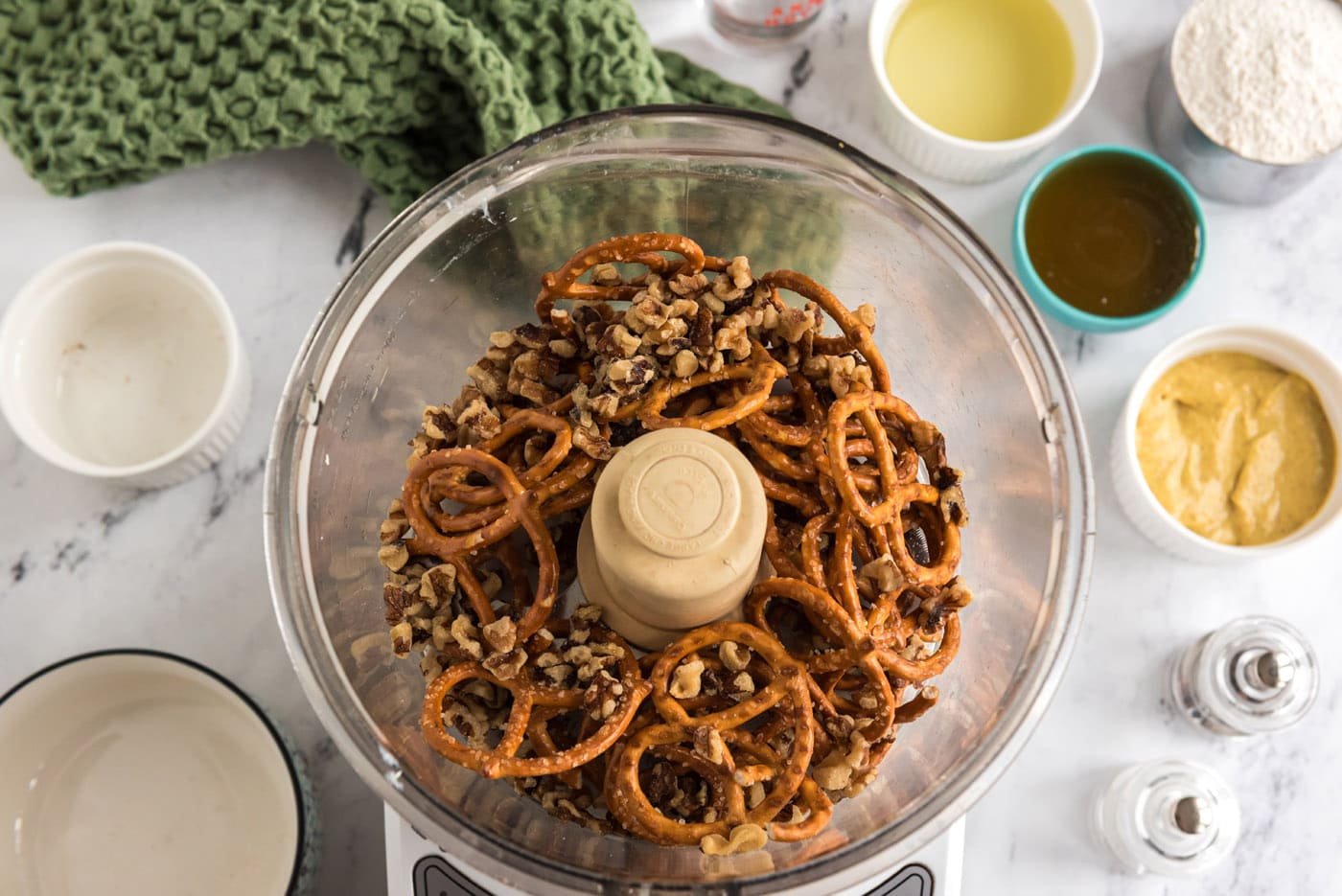 pretzels and walnuts in a food processor bowl