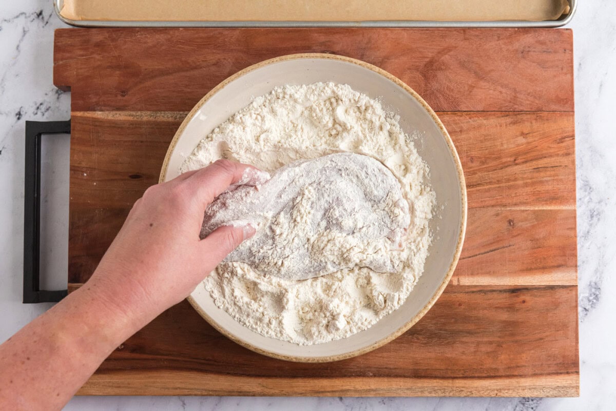 dredging chicken breast in flour
