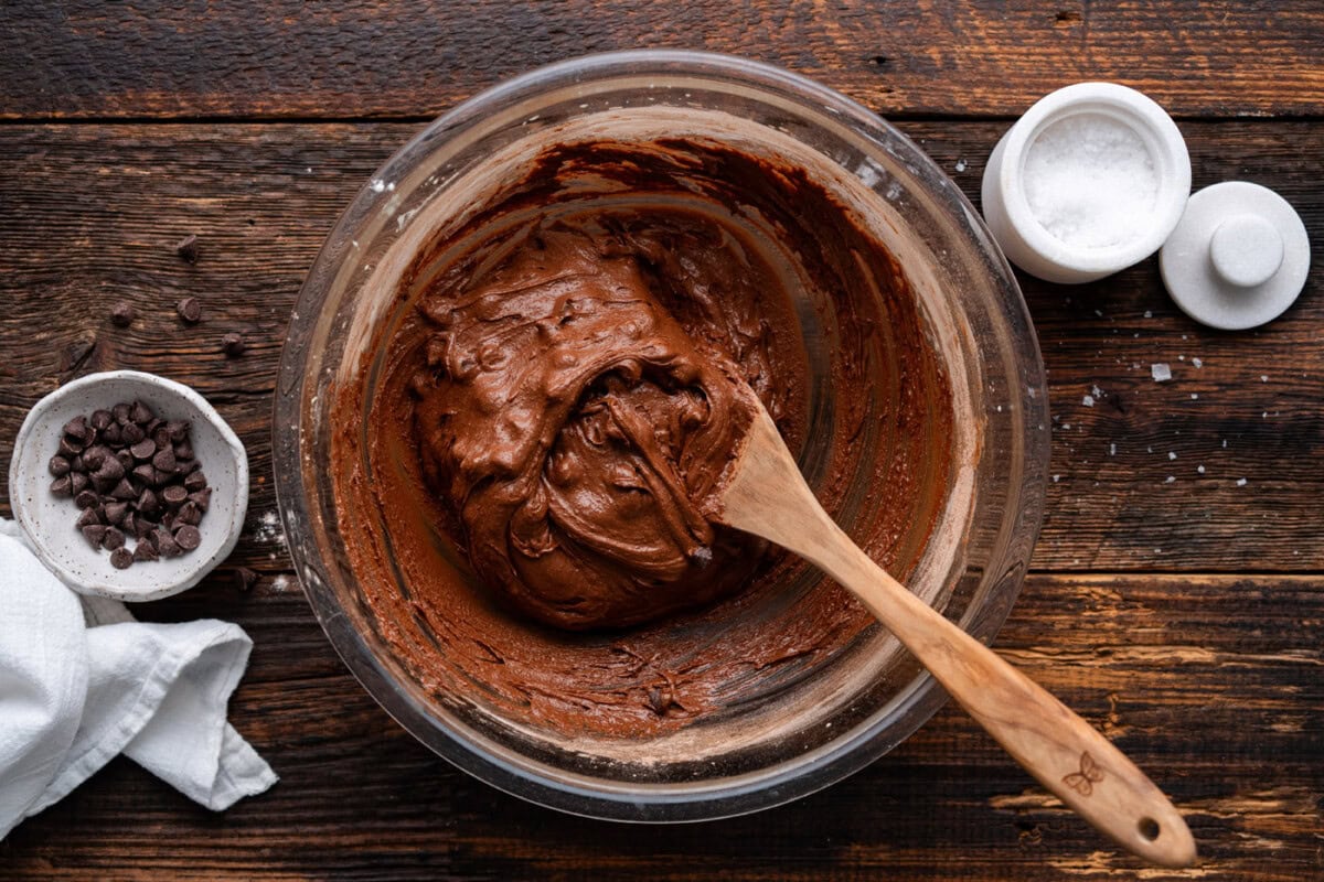 salted brownie cookie dough in a bowl with wooden spoon
