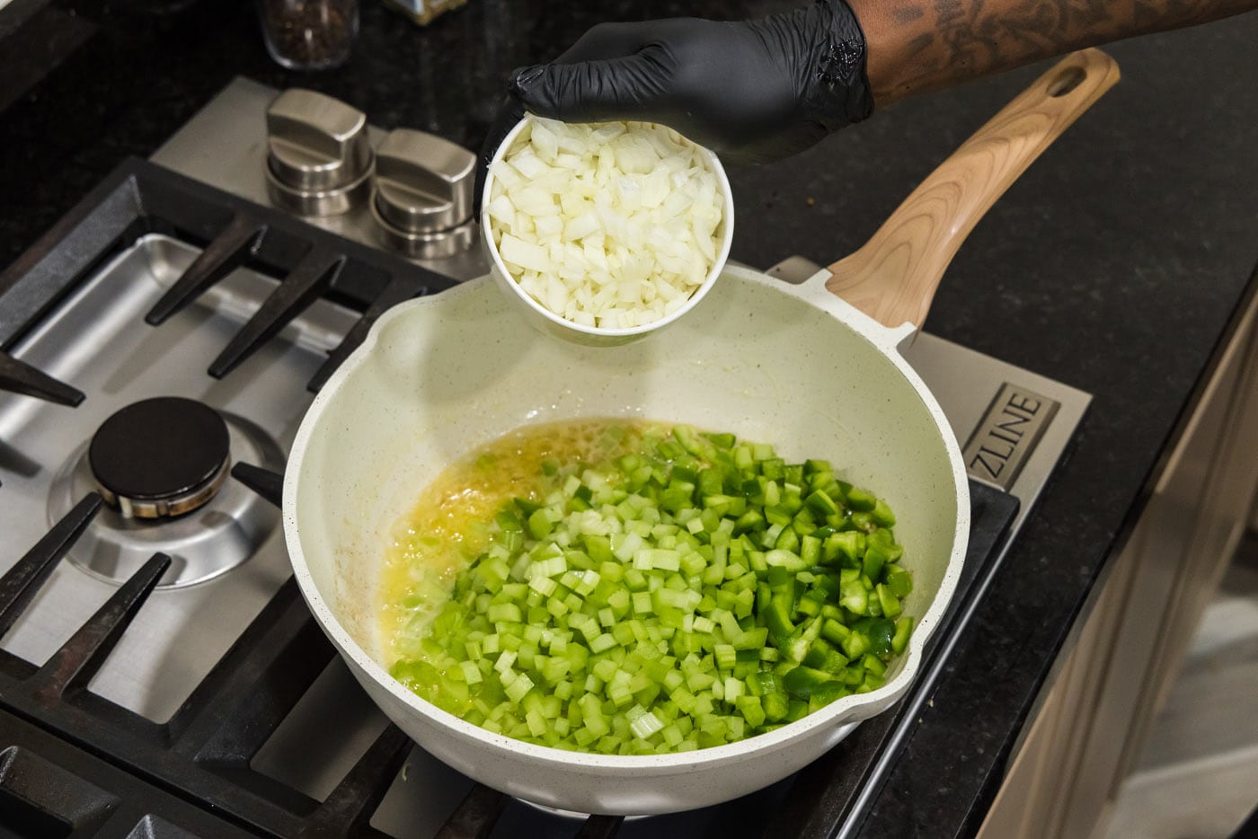 cooking celery, green pepper, and onion in a skillet with butter