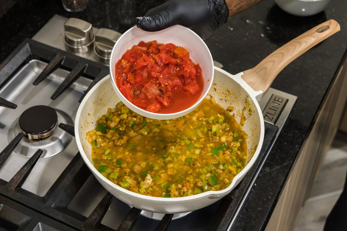 adding fire roasted tomatoes to shrimp creole