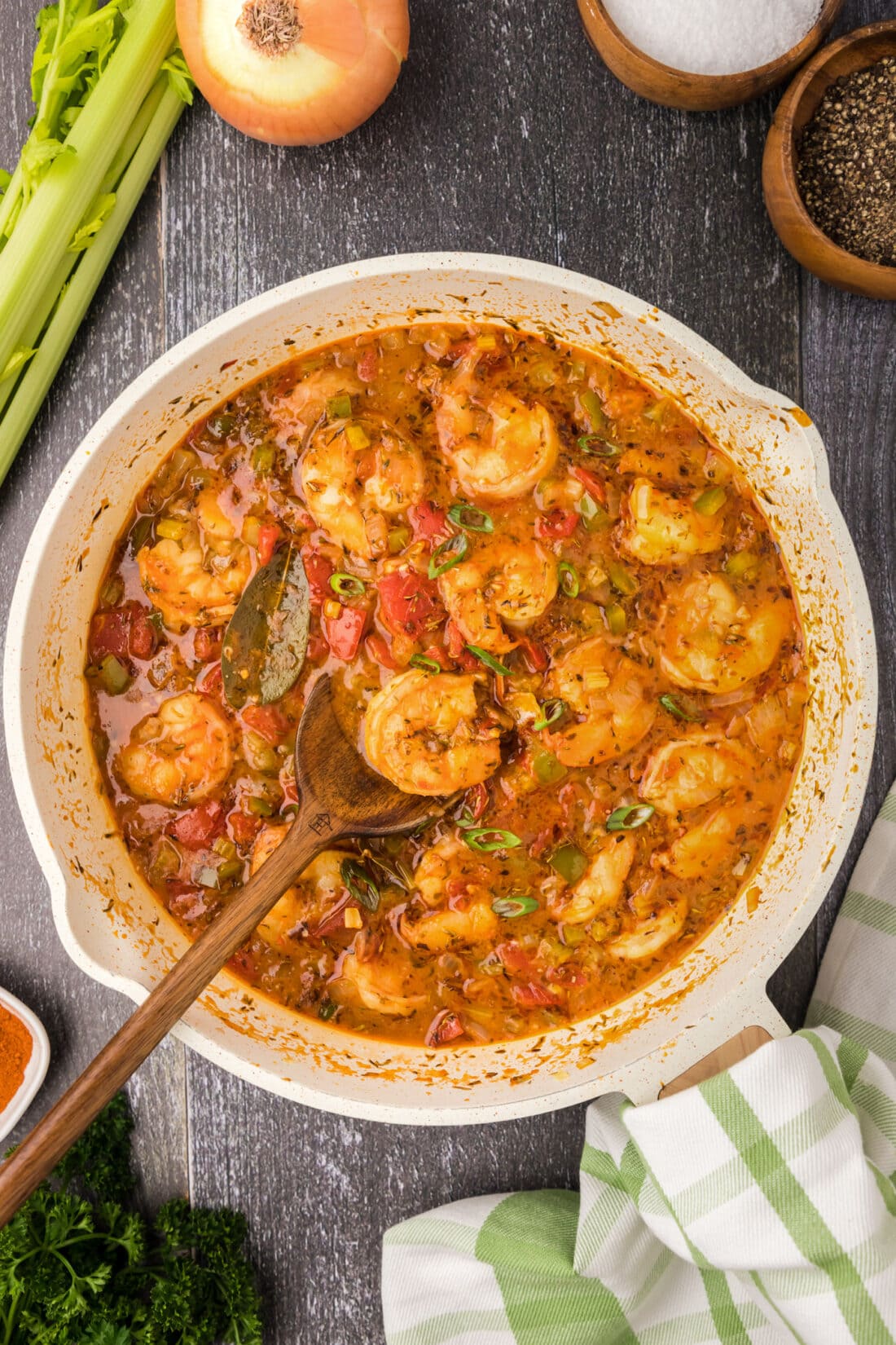 Skillet of Shrimp Creole with a spoon in it