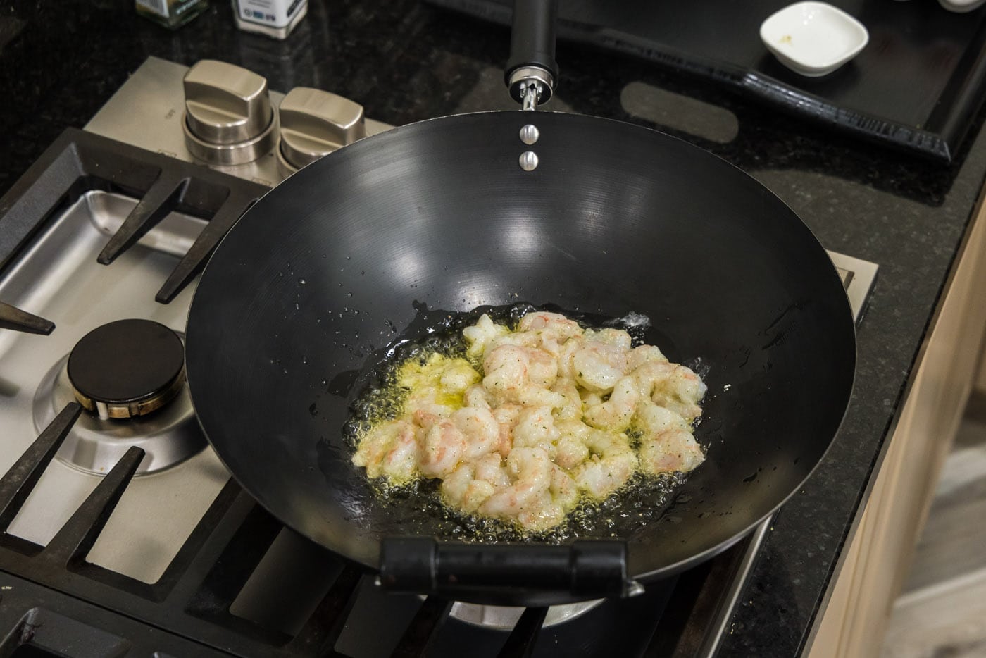 cooking shrimp in a wok with oil