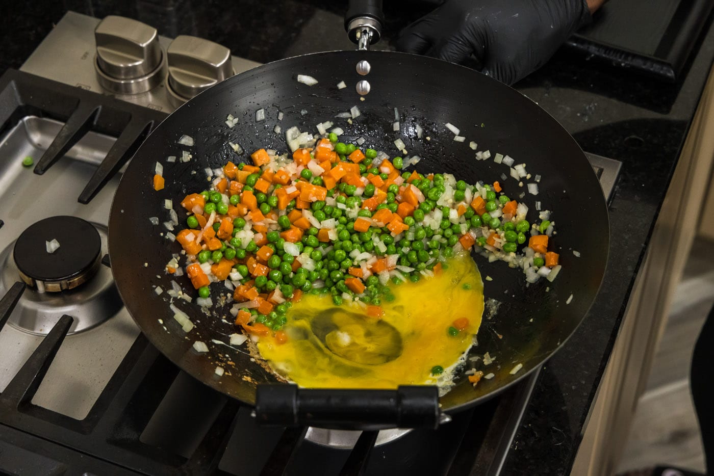 eggs scrambling next to stir fried vegetables