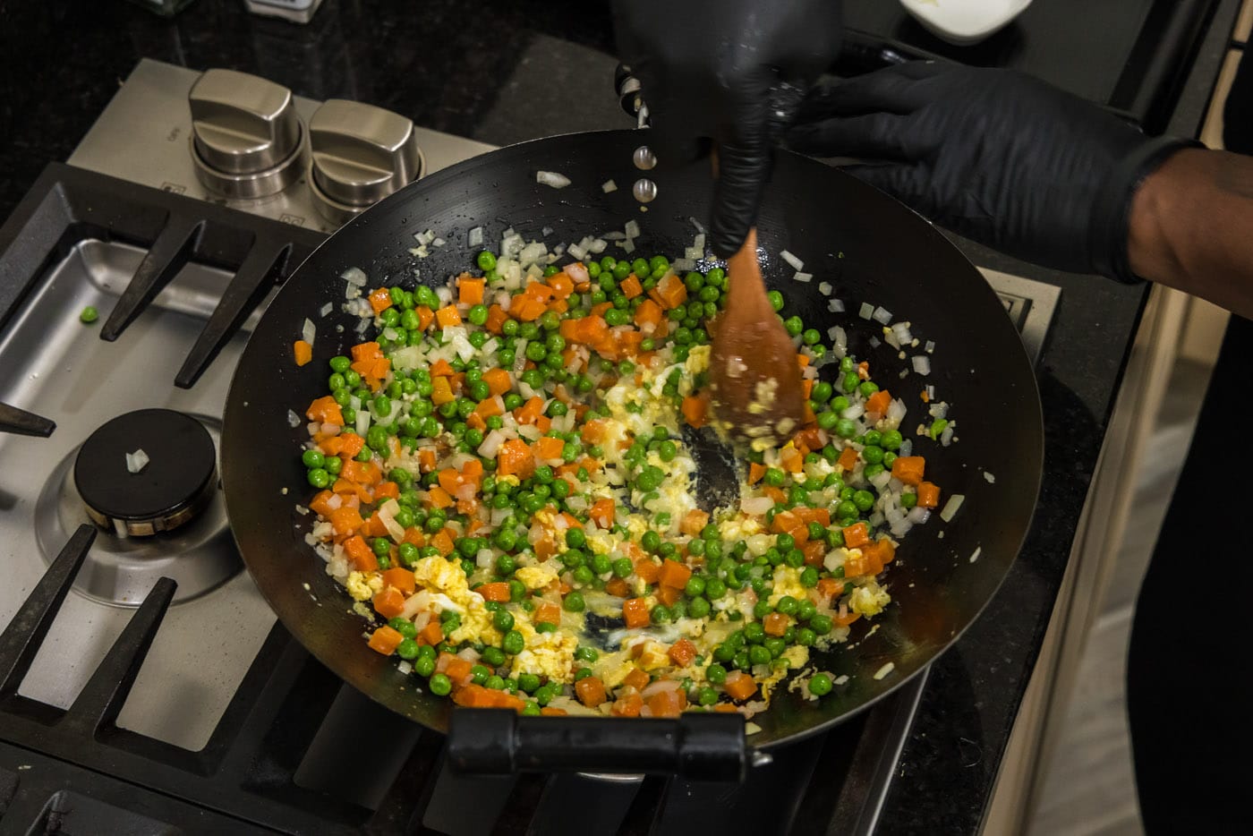 stirring cooked egg into stir fry vegetables