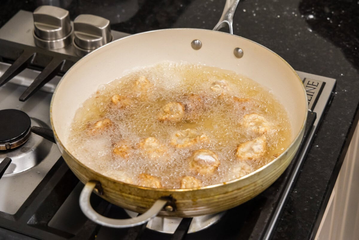 frying dredged pork in hot oil
