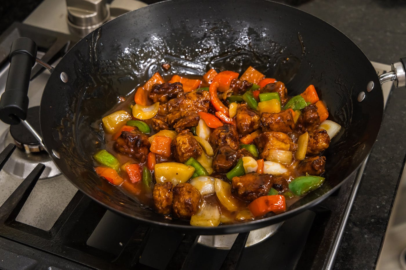 sweet and sour pork in a wok