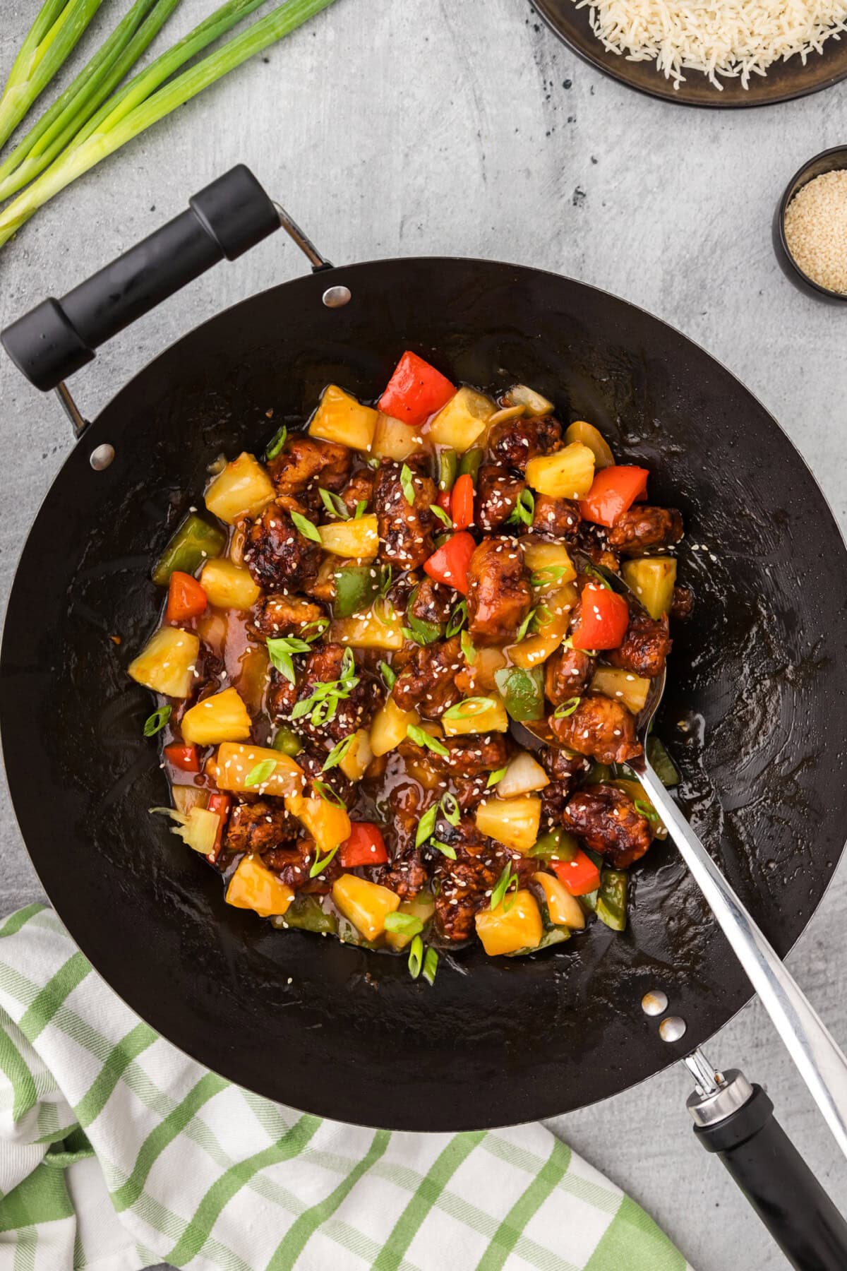 Wok of Sweet and Sour Pork with a spoon in it