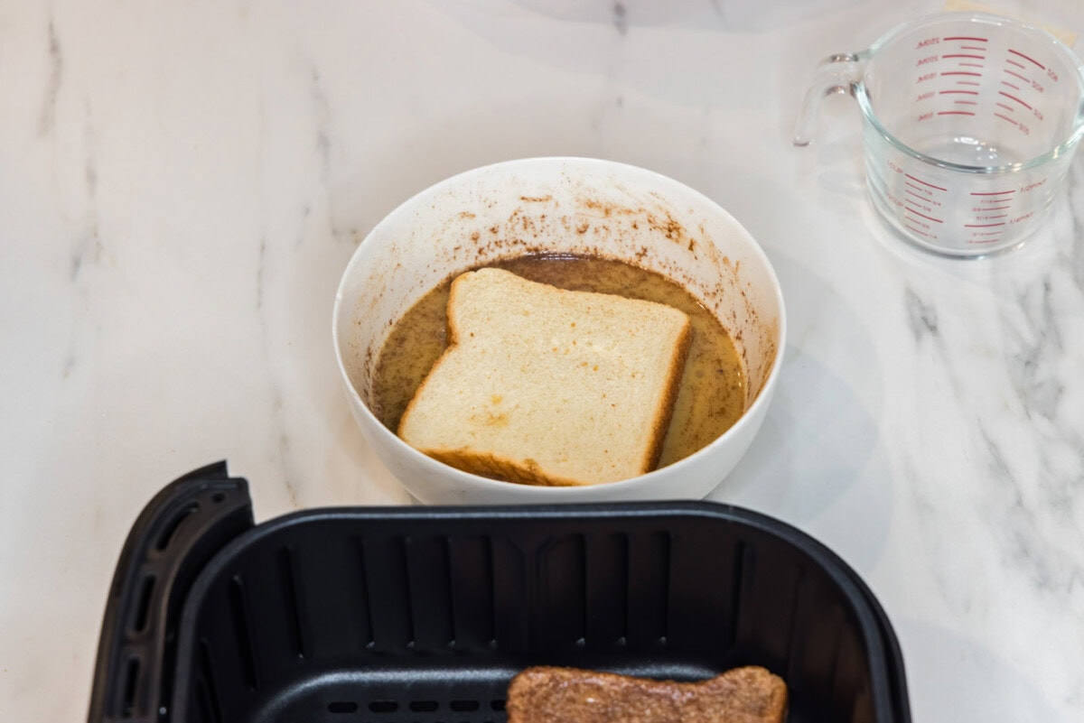 dipping bread into egg mixture