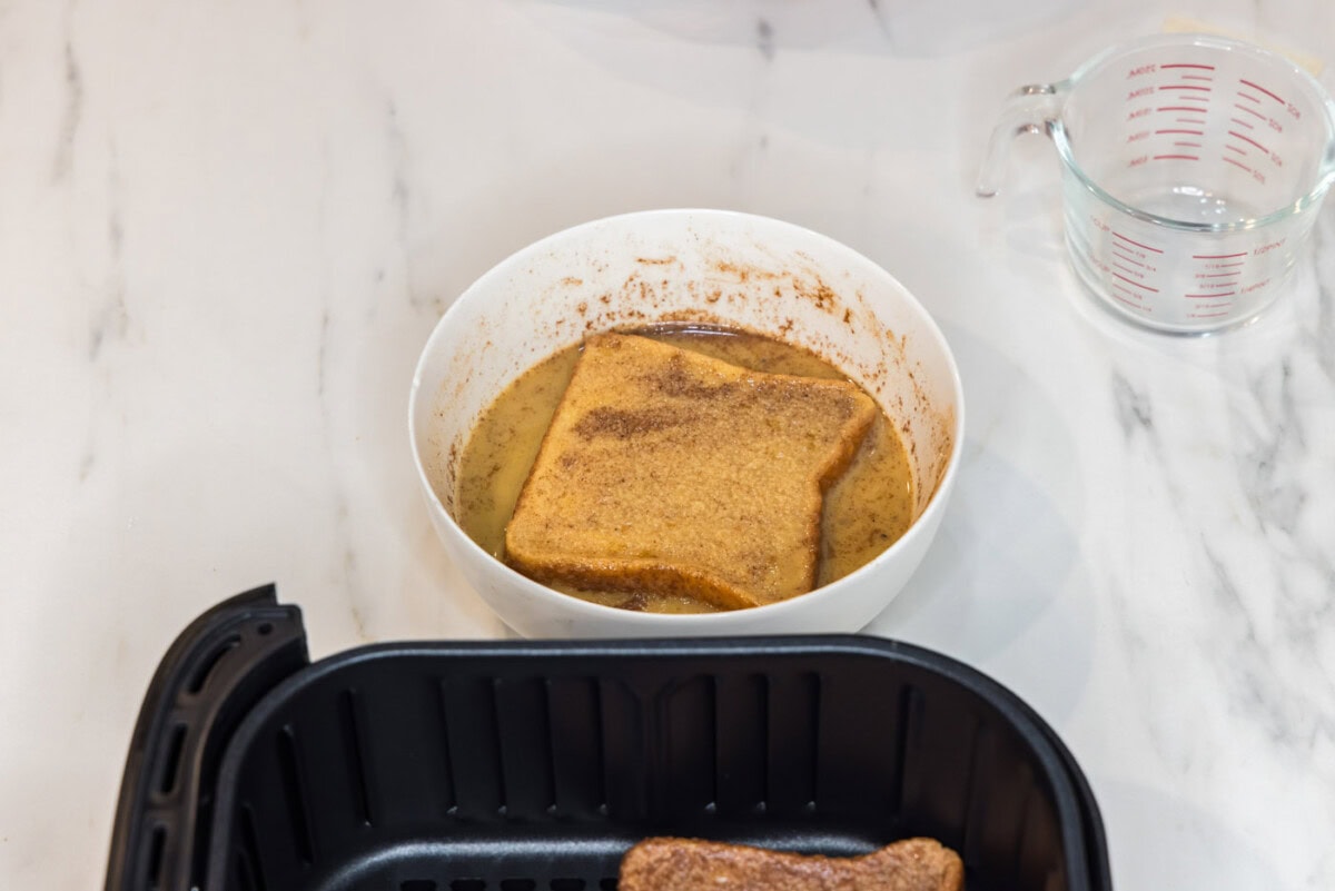 coating bread slice in egg mixture