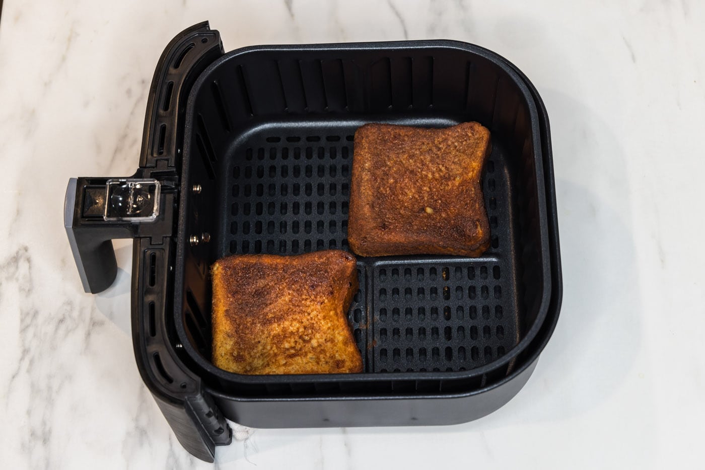 Cooked French toast in air fryer basket