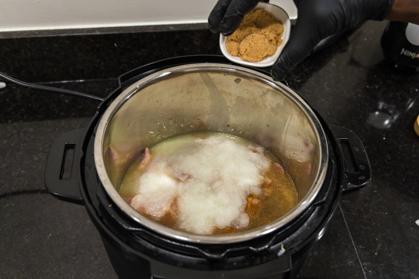 sprinkling BBQ chicken with brown sugar in instant pot
