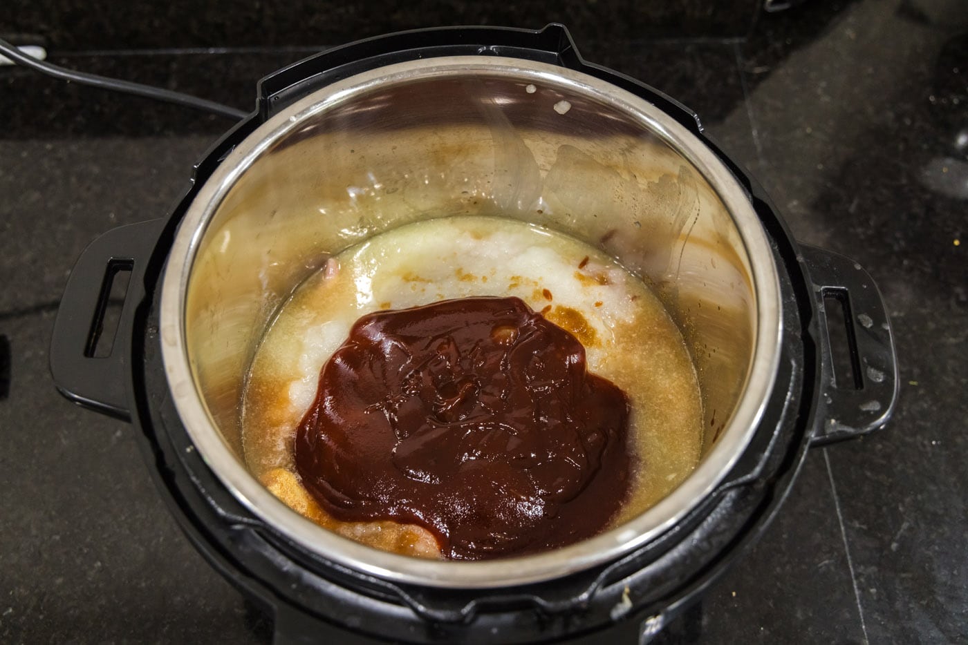 barbecue sauce added to instant pot with chicken mixture
