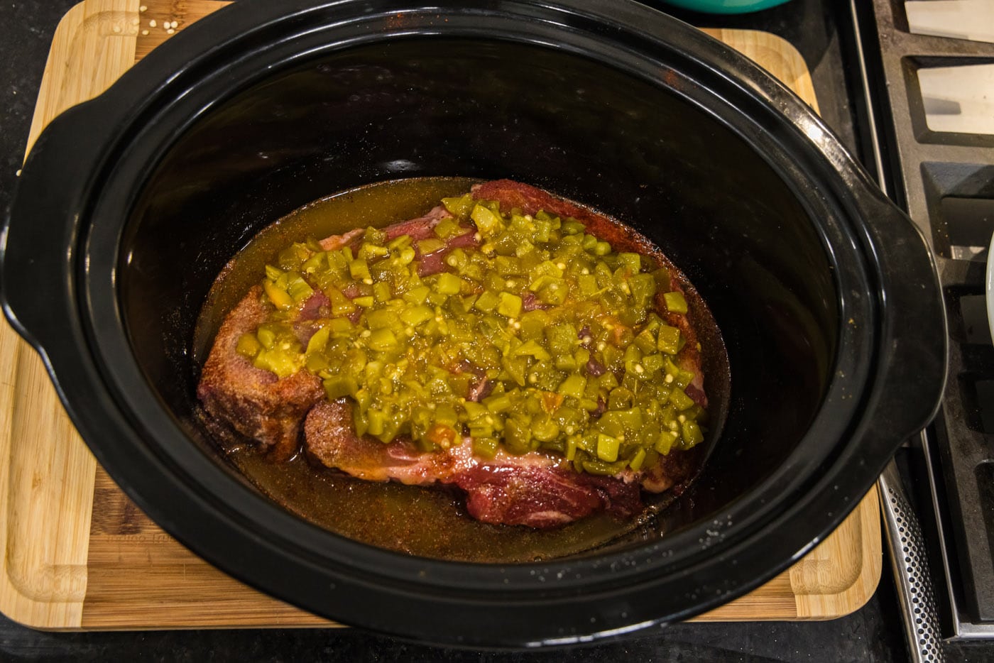 green chiles on top of chuck roast in crockpot