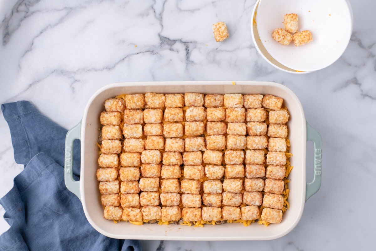 tater tots on top of ground beef and shredded cheese casserole